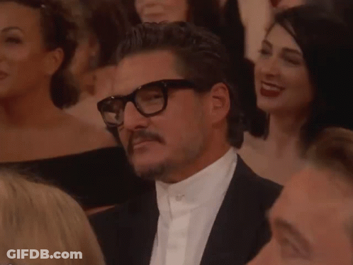 Man With Glasses And Mustache Sitting In Crowd GIF