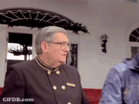 Man With Glasses And Name Tag At White Building GIF
