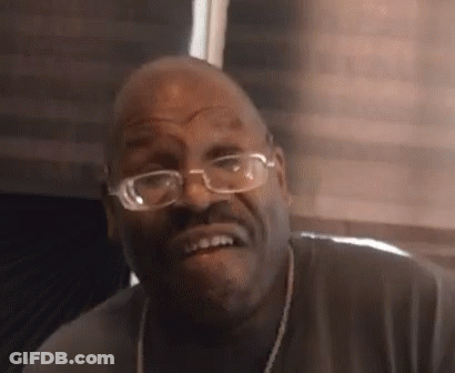 Man With Glasses And Necklace Making Funny Face GIF