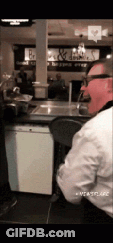Man With Glasses And Pink Mask At Counter GIF