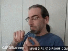 Man With Glasses And Ponytail Eating Food GIF