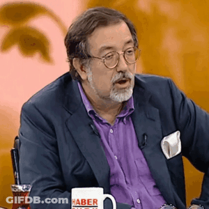 Man With Glasses And Purple Shirt Holding Cup Saying Haber GIF