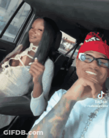 Man With Glasses And Red Bandana Next To Woman In Car GIF