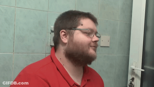 Man With Glasses And Red Shirt Standing By Door GIF