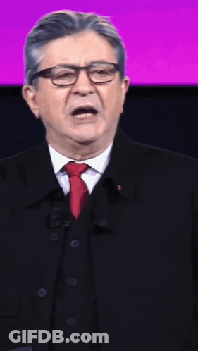 Man With Glasses And Red Tie Speaking Into Microphone GIF
