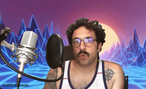 Man With Glasses And Tattoo Singing Into Microphone GIF
