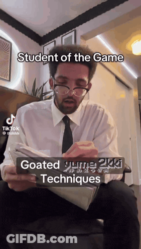 Man With Glasses And Tie Reading Student Of The Game GIF