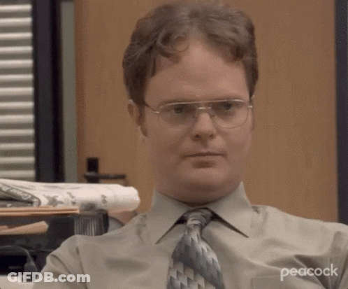 Man With Glasses And Tie Sitting At Desk GIF