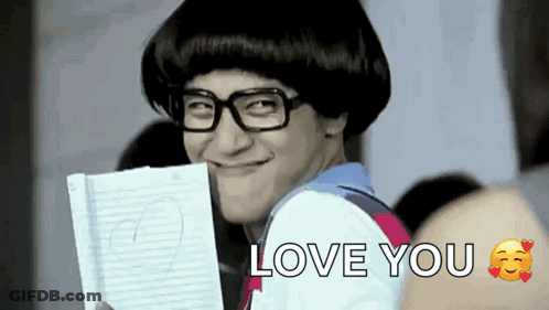 Man With Glasses And Wig Holding Paper And Smiling GIF