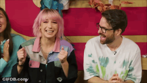 Man With Glasses And Woman With Pink Hair Laughing GIF