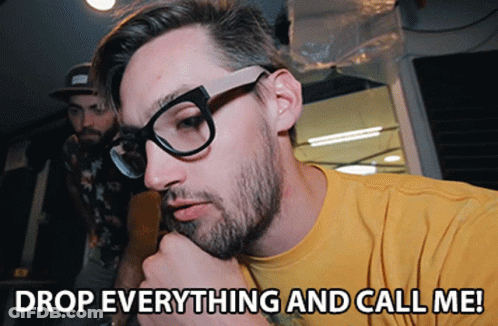 Man With Glasses And Yellow Shirt Saying Drop Everything And Call Me GIF