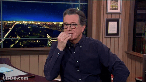 Man With Glasses At Desk Hand On Chin GIF