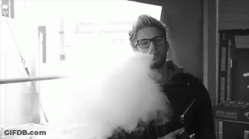 Man With Glasses Blowing Smoke Black And White GIF