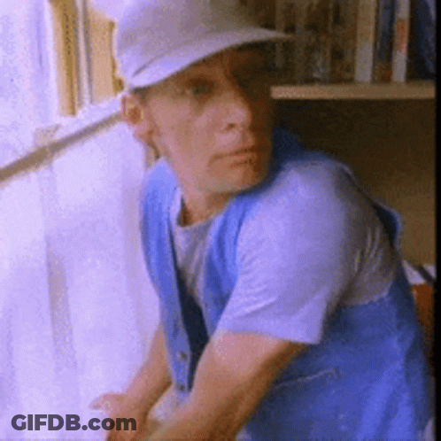 Man With Glasses Blue Shirt Holding Paper WS GIF