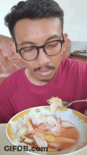Man With Glasses Eating Soup With Fork GIF