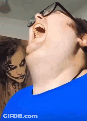 Man With Glasses Funny Face In Front Of Joker Painting GIF
