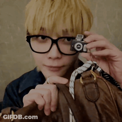 Man With Glasses Holding Camera Saying Oi GIF