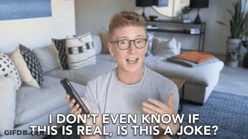 Man With Glasses Holding Cell Phone Saying I Don't Even Know If This Is Real GIF