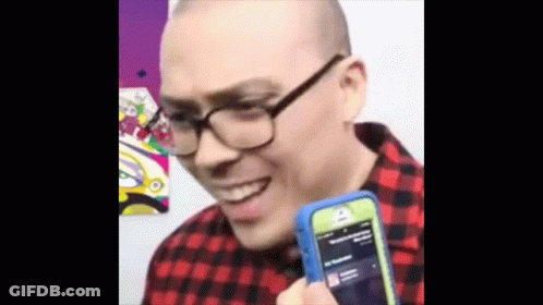 Man With Glasses Holding Cell Phone Smiling GIF