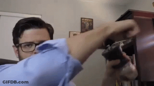 Man With Glasses Holding Gun GIF