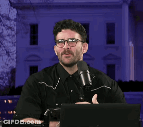 Man With Glasses Holding Microphone GIF
