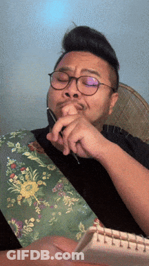 Man With Glasses Holding Pen In Mouth GIF
