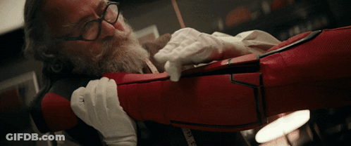 Man With Glasses Holding Red Item With Measuring Tape GIF
