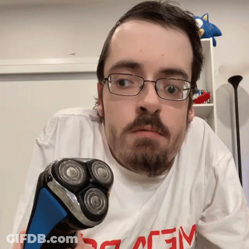 Man With Glasses Holding Shaver GIF