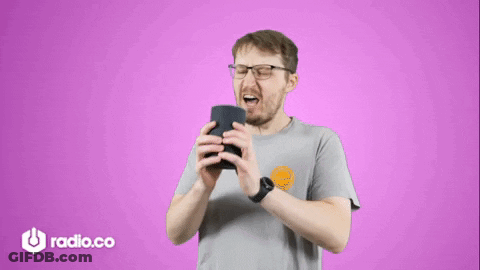 Man With Glasses Holding Speaker In Front Of Purple Background Saying Radio.co GIF