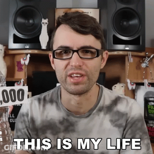 Man With Glasses Holding Water Bottle And Sign Saying This Is My Life GIF