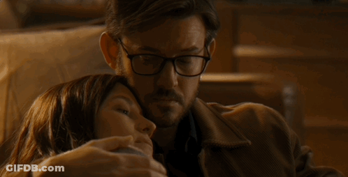 Man With Glasses Hugging Woman Laying On His Chest GIF