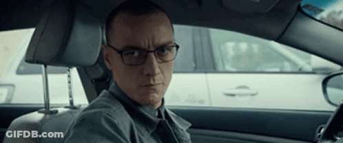 Man With Glasses In Driver's Seat Looking At Camera GIF