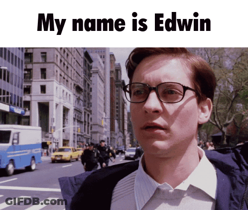 Man With Glasses In Front Of City Street Saying My Name Is Edwin GIF