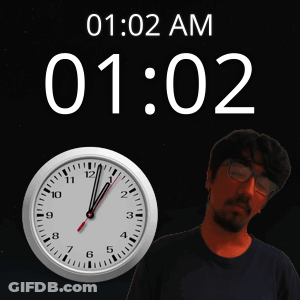 Man With Glasses In Front Of Clock Saying 1:02 AM GIF