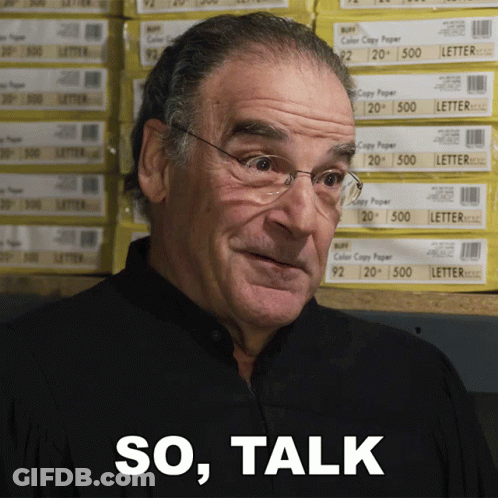 Man With Glasses In Front Of Paper Stacks GIF