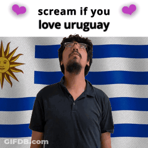 Man With Glasses In Front Of Uruguay Flag GIF