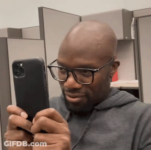 Man With Glasses Looking At Phone GIF