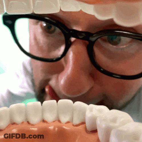 Man With Glasses Looking At Teeth Model GIF