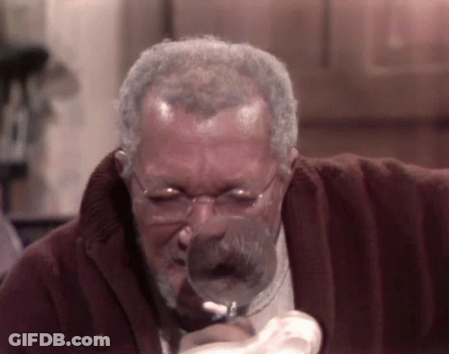 Man With Glasses Looking Through Magnifying Glass GIF