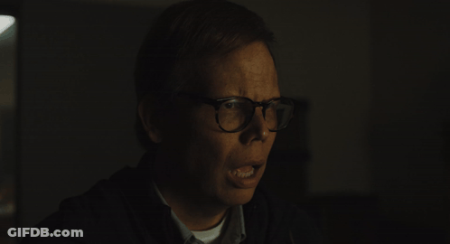 Man With Glasses Making Funny Face In Dark GIF