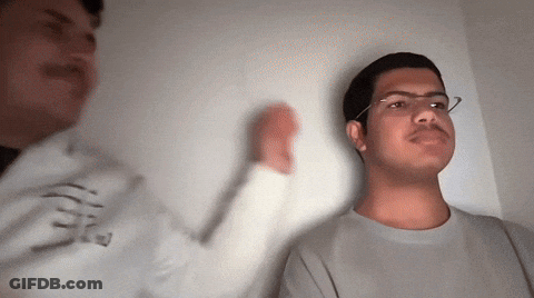 Man With Glasses Next To Man In E Sweatshirt GIF
