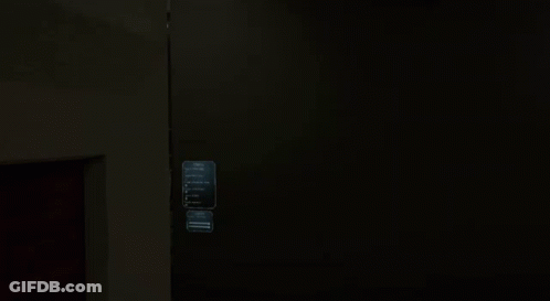 Man With Glasses Peeking From Behind Wall GIF