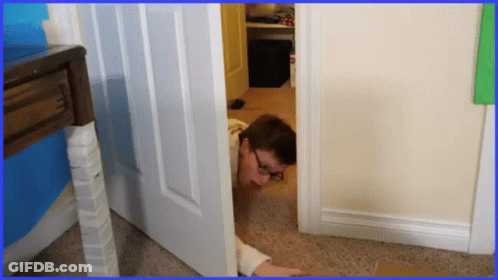 Man With Glasses Peeking Out Of Doorway GIF