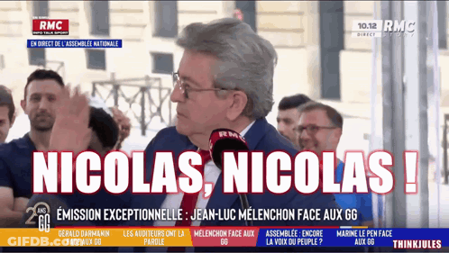 Man With Glasses Saying Nicolas Nicolas Into Microphone GIF