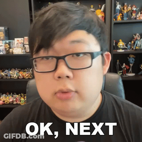 Man With Glasses Saying Ok Next With Figurine Shelf GIF