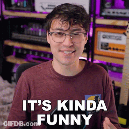 Man With Glasses Says It's Kinda Funny At Microphone GIF