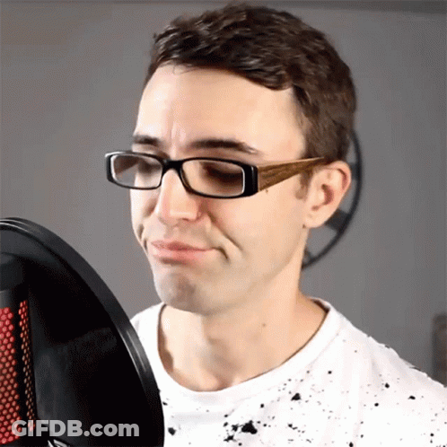 Man With Glasses Singing Into Microphone Making Face GIF