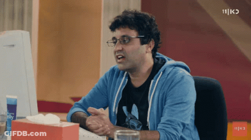 Man With Glasses Sitting At Desk With Tissues GIF