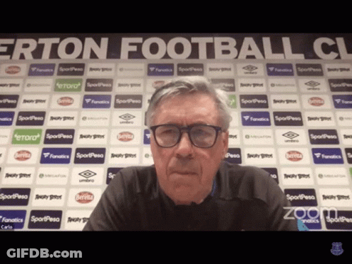 Man With Glasses Sitting By Ertan Football Club GIF
