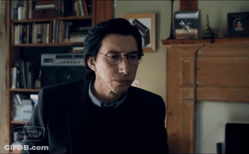 Man With Glasses Sitting By Fireplace GIF